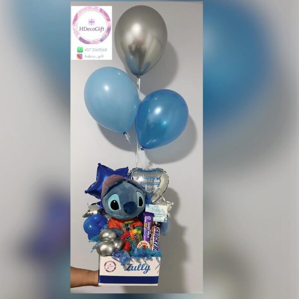 Blue-themed birthday gift box with balloons, plush toy, and assorted snacks